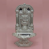 Decorative silver temple structure on a pink background
