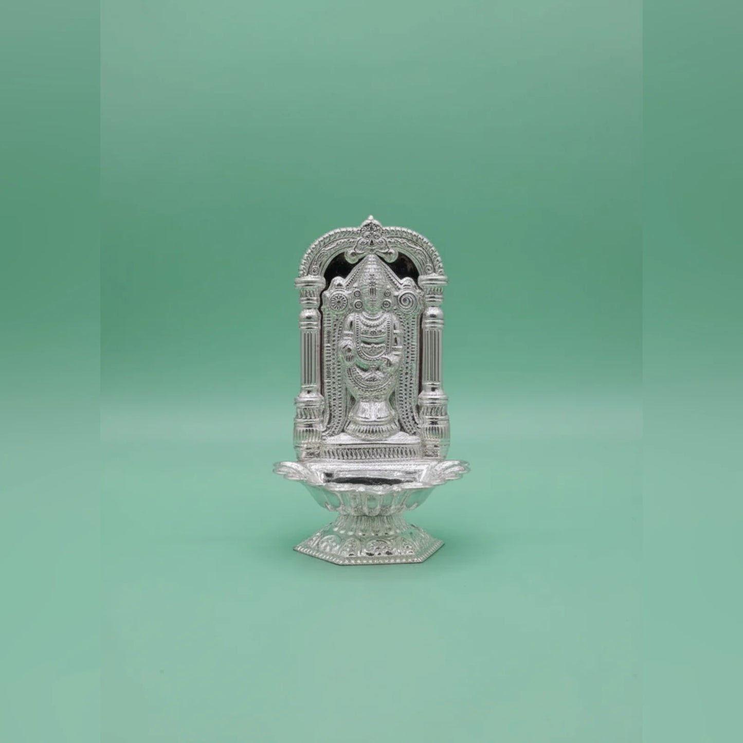 Decorative silver temple on a green background