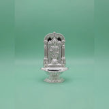 Decorative silver temple on a green background
