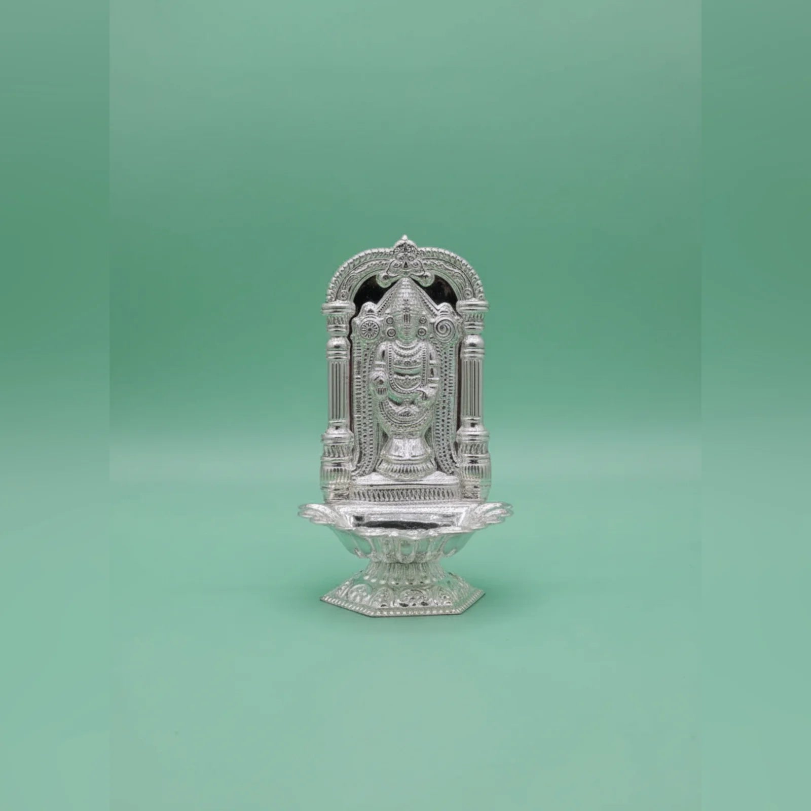 Decorative silver temple on a green background