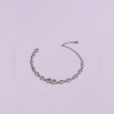 Silver chain bracelet on a light purple background