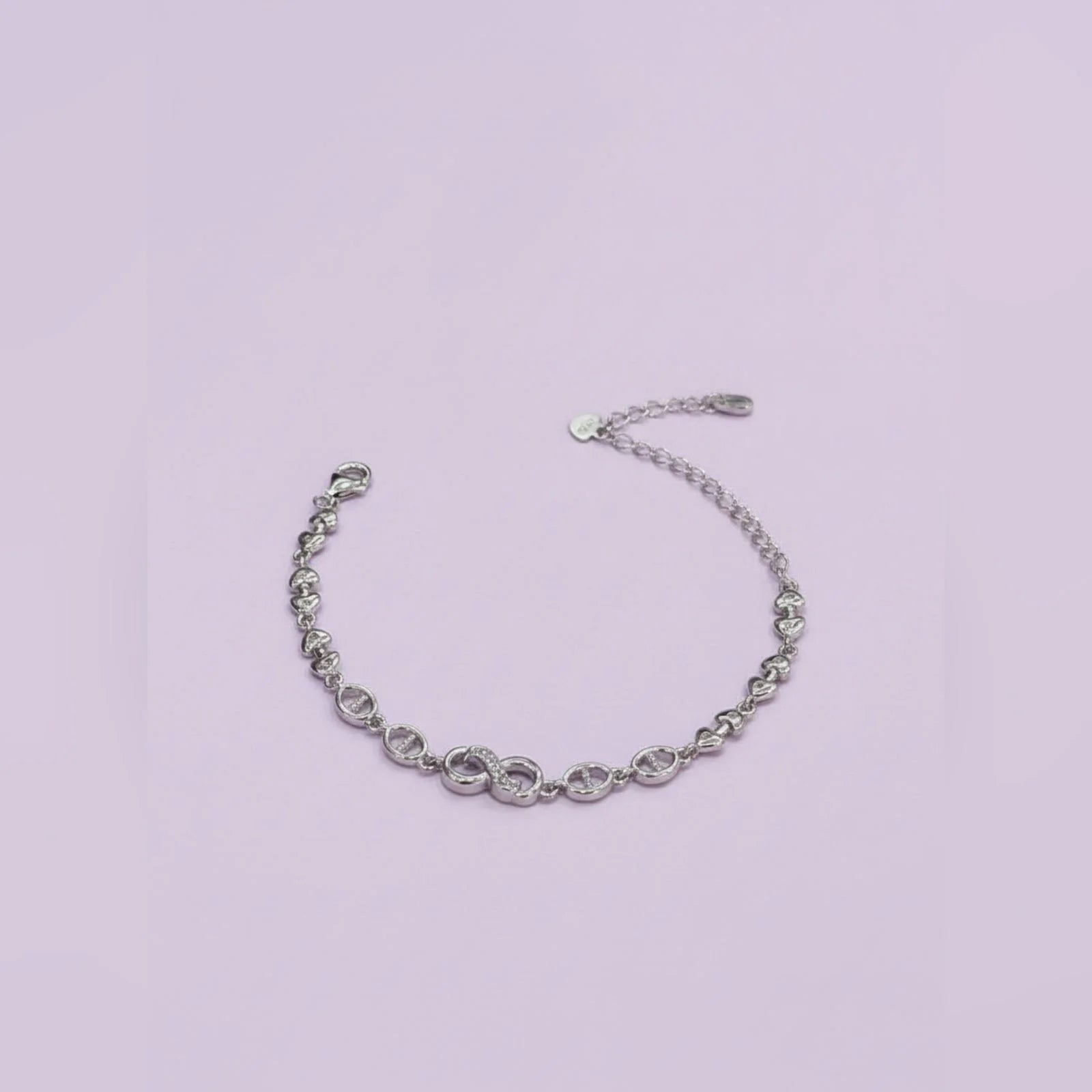 Silver chain bracelet on a light purple background