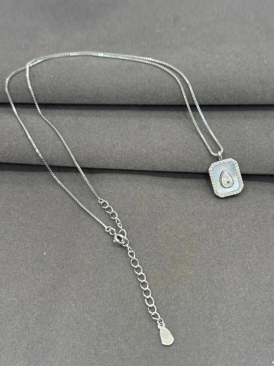 Pure 925 Silver necklace with a pendant on a gray surface