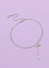 Pure 925 Silver necklace with leaf pendants on a light purple background