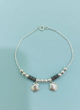 Bracelet with shells on a light blue background