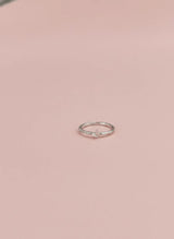 Silver ring on a pink background
