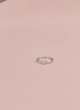 Silver ring on a pink background