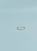 Silver ring on a light blue background