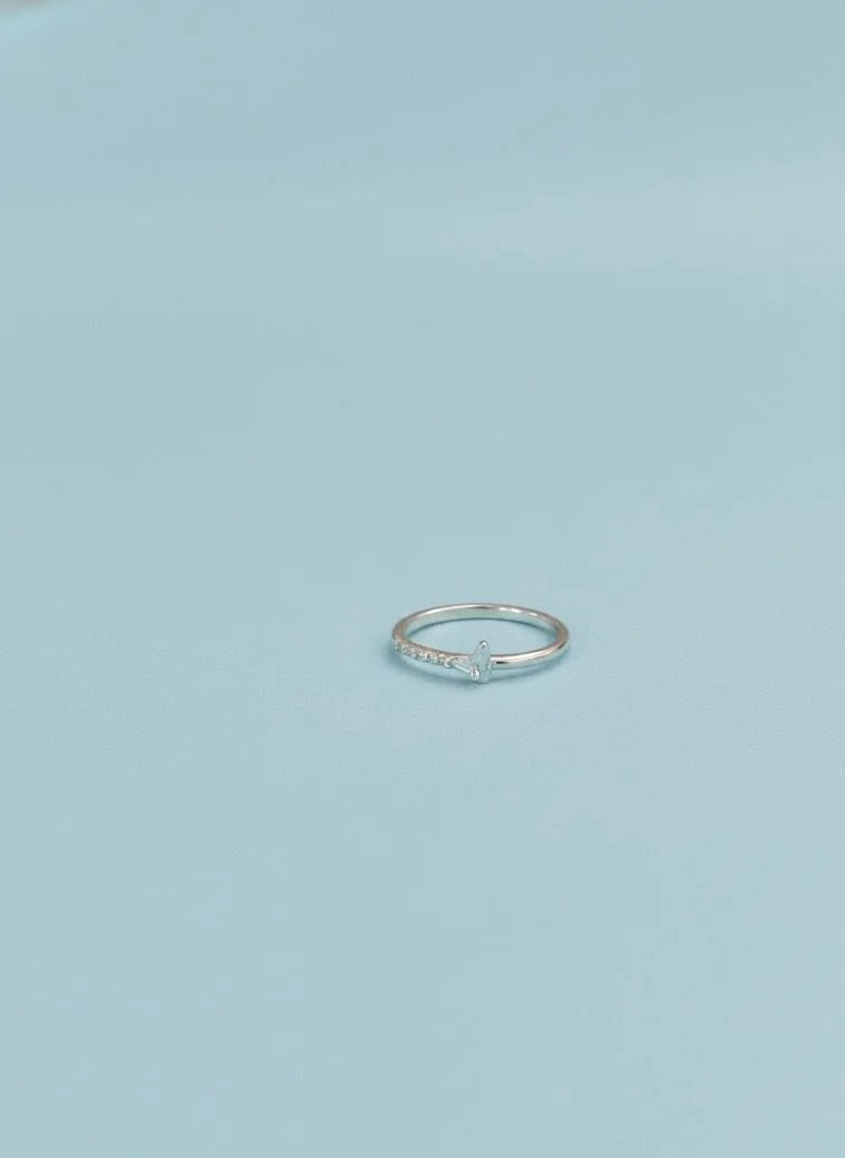 Silver ring on a light blue background