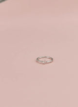 Silver ring on a pink background