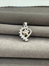 Silver pendant with star design on a gray fabric background