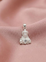 Silver Buddha pendant on a pink fabric background
