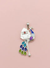 Colorful peacock-shaped pendant on a pink background