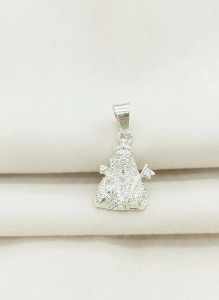 Silver pendant on a beige fabric background