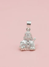 Silver pendant with a figure on a pink background