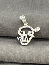 Silver pendant with leaf design on a gray fabric background