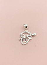 Silver pendant with intricate design on a pink background