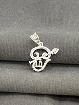 Silver pendant on a gray fabric background