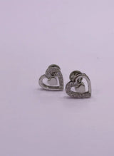 Heart-shaped earrings with embedded stones on a light purple background