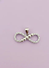Infinity symbol pendant on a light purple background