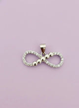 Infinity symbol pendant on a light purple background