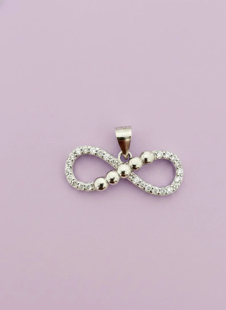 Infinity symbol pendant on a light purple background