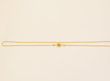 Gold necklace on a beige background