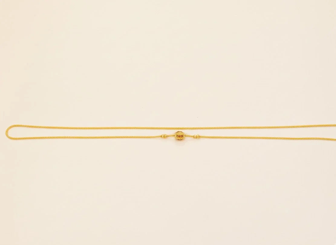 Gold necklace on a beige background