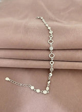 Silver bracelet on a pink satin background
