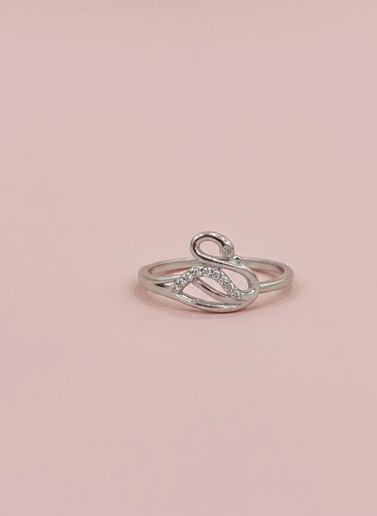 Silver ring with small diamonds on a pink background