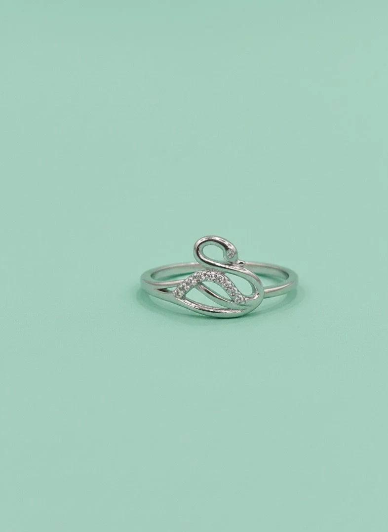 Silver ring on a light green background