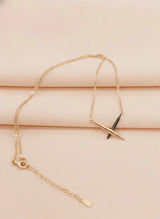 Rose gold bracelet with a unique design on a beige surface