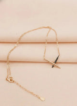 Rose gold bracelet with a unique design on a beige surface