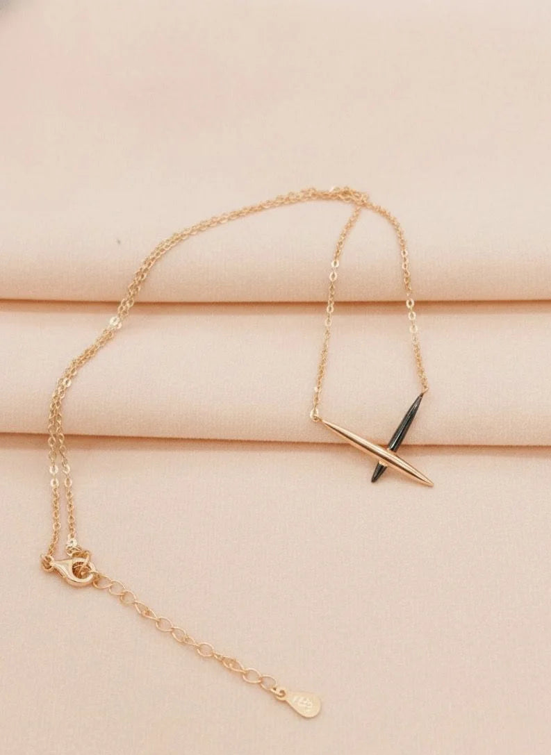 Rose gold bracelet with a unique design on a beige surface